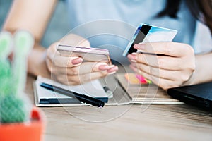 Woman hand using mobile phone and credit card for online shopping and payment