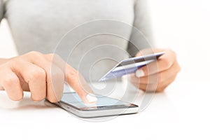closeup woman hand using phone and credit card shopping
