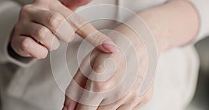 Closeup of a woman hands applying hand cream to skin