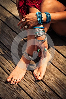 Closeup of woman hands and feet with boho summer fashion details