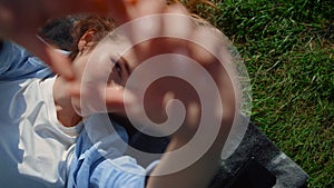 Closeup woman hands in green grass background. Playful female stretching hands.