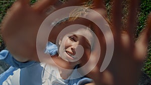 Closeup woman hands in green grass background. Playful female stretching hands.