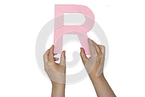 Closeup woman hands holding the alphabet R to form a word