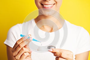 Closeup Of Woman Hands Holding White Eyelense Container