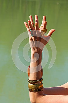 Closeup of woman hands in mudra gesture practice yoga meditation outdoor by the lake summer day