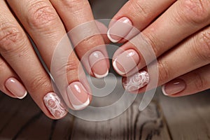 Closeup of woman hands with nail design.