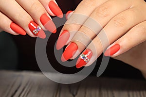 Closeup of woman hands with nail design.