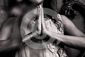 Closeup of woman hands in namaste gesture outdoor shot