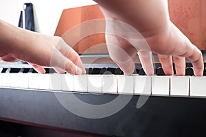 Closeup woman hands playing piano. Music and art background.