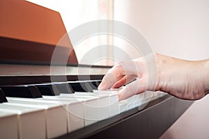 Closeup woman hands playing piano. Music and art background.