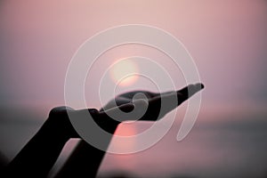 Closeup woman hands praying for blessing from god during sunset