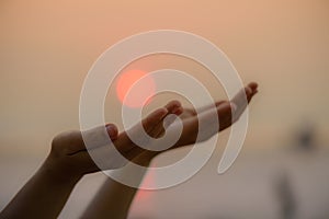 Closeup woman hands praying for blessing from god during sunset