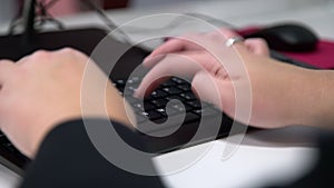 Closeup of woman hands typing keyboard at the office. Business woman or secretary working online