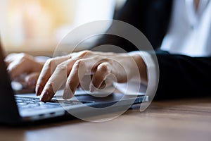 Closeup woman hands typing on laptop computer keyboard.