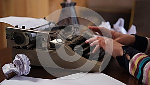 Closeup of Woman Hands Typing on a Typewriter