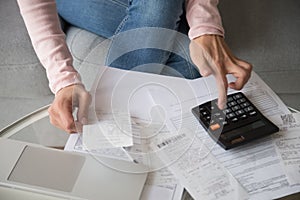 Closeup woman hands using calculator cost money manage family budget