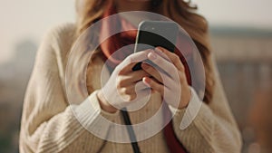 Closeup woman hands using phone outdoors. Unrecognizable girl holding cellphone.