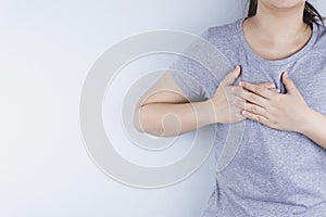 Closeup woman having heart attack or chest pain. Health care and medical concept