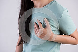 Closeup woman having heart attack. Woman touching breast and having chest pain. Healthcare And Medical concept