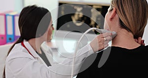 Closeup of woman having ultrasound scan of neck doctor