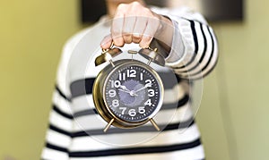 closeup woman holding alarm 7 o` Clock.