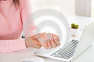 Closeup woman holding her wrist pain