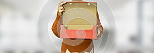 Closeup woman holding Open kraft carton box. Brown cardboard box with open cover mockup. Delivery or unpacking concept