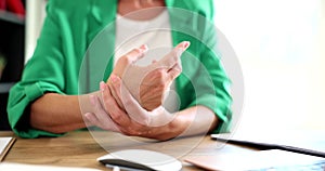Closeup woman holding wrist pain from using computer