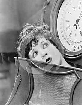 Closeup of woman inside clock