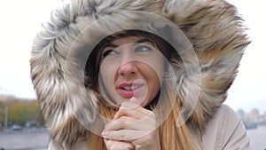 Closeup Of Woman In A Jacket With The Hood She Closed From The Strong Cold Wind