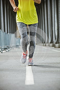 Closeup on woman jogging on Pont de Bir-Hakeim bridge in Paris
