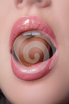 Closeup of woman lips with candy