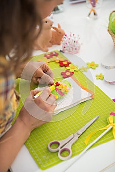 Closeup on woman making easter decorative egg