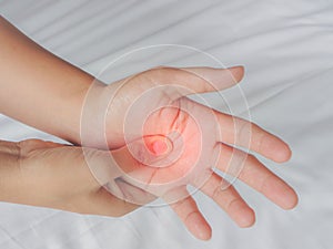 Closeup woman massaging her painful hand at home
