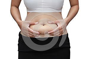 Closeup woman measuring stomach fat with her hands isolated and white background with clipping path
