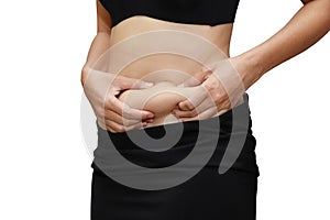 Closeup woman measuring stomach fat with her hands isolated and white background with clipping path