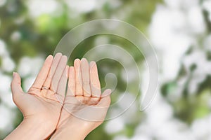 Closeup of woman open two empty hands with palms up for pray to God