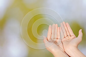 Closeup of woman open two empty hands with palms up for pray to God