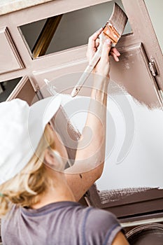 Closeup of Woman Painting Kitchen Cabinets