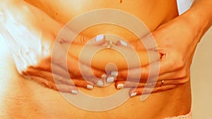 Closeup of woman pinching belly fat