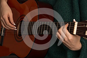 Closeup of woman playing guitar