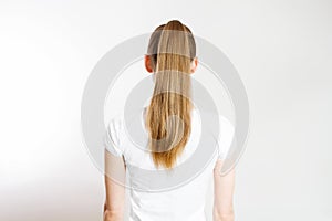 Closeup woman ponytail back view isolated on white background. Hair Natural blonde straight long Hairstyle. Easy quick simple photo