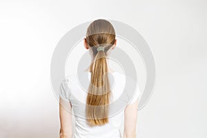 Closeup woman ponytail back view isolated on white background. Hair Natural blonde straight long Hairstyle. Easy quick simple photo