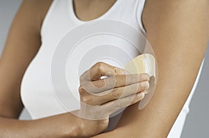 Closeup Of Woman Putting Nicotine Patch On Arm photo