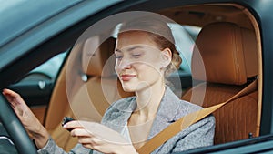 Closeup woman receiving car keys to new vehicle. Businesswoman sitting in car