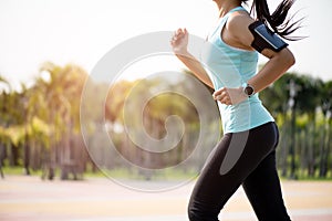 Closeup woman running towards on the road side. Step, run and outdoor exercise activities concept