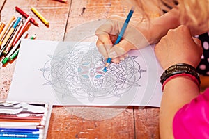 Closeup of woman`s hand drawing mandala photo