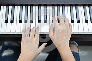 Closeup woman's hand playing piano. Favorite classical music. Piano learning chords at home