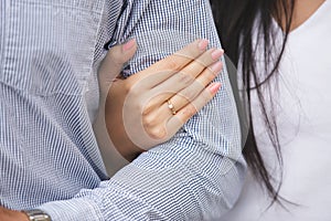 closeup of a woman& x27;s hand wearing engagement ring