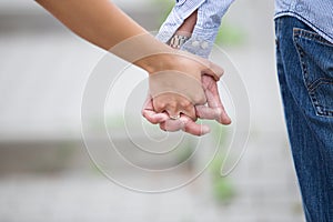 closeup of a woman& x27;s hand wearing engagement ring